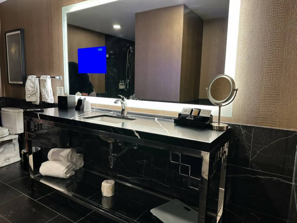 nice oversized vanity with television in mirror at The Warrior Hotel, Sioux City