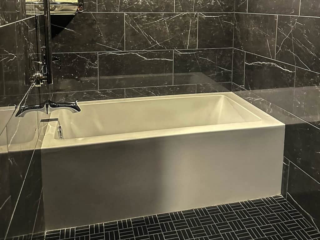 oversized soaking tub at opposite end of shower at The Warrior Hotel in Sioux City
